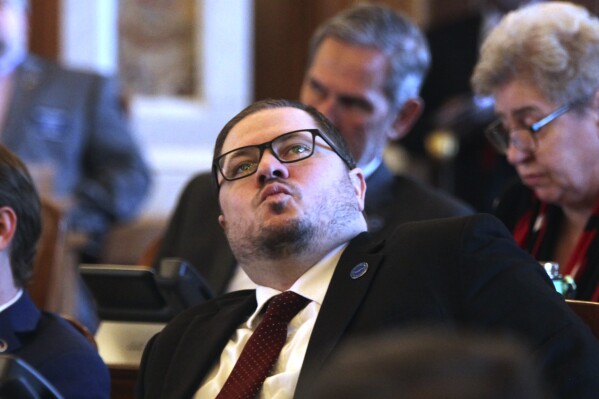 Kansas state Rep. Nick Hoheisel, R-Wichita, watches an electronic tally board in the House as it approves a bill requiring pornography websites to verify the age of Kansas visitors, Tuesday, March 26, 2024, at the Statehouse in Topeka, Kan. The measure is going to Gov. Laura Kelly, and at least eight other states have such laws. (AP Photo/John Hanna)