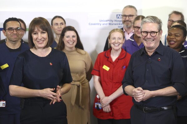 Britain's Prime Minister Keir Starmer and Chancellor Rachel Reeves with members of staff, during a visit to University Hospital Coventry and Warwickshire, in Coventry, England, Thursday, Oct. 31, 2024. (AP Photo/Darren Staples, pool)