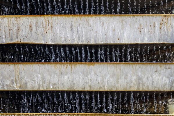 Water passes through a filtration device at a drinking water factory on World Water Day in Kathmandu, Nepal, March 22, 2024. (AP Photo/Niranjan Shrestha)