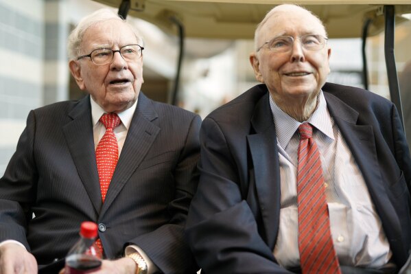 File - Berkshire Hathaway Chairman and CEO Warren Buffett, left, and Vice Chairman Charlie Munger, briefly chat with reporters May 3, 2019, one day before Berkshire Hathaway's annual shareholders meeting in Omaha, Neb. Berkshire Hathaway says Munger, who helped Warren Buffett build an investment powerhouse, has died. (AP Photo/Nati Harnik, File)