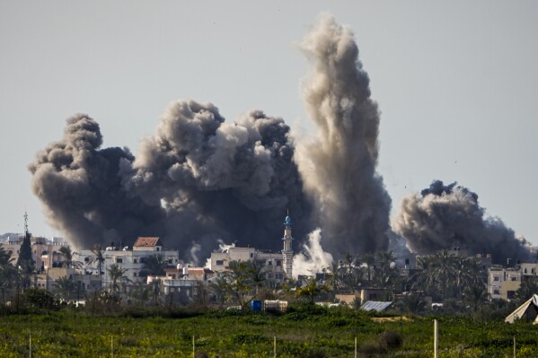 Smoke and explosions after Israeli bombing inside the Gaza Strip, as seen from southern Israel, Sunday, Feb. 11, 2024.  Forces are fighting Palestinian militants across Gaza in the war sparked by Hamas' October 7 attack on Israel.  (AP Photo/Ariel Shalit)