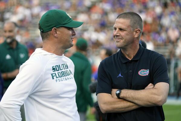 South Florida head coach Jeff Scott, left, and Florida head coach Billy Napier greet each other at midfield before an NCAA college football game, Saturday, Sept. 17, 2022, in Gainesville, Fla. (AP Photo/John Raoux)