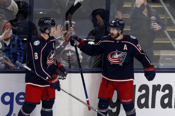 Columbus Blue Jackets forward Oliver Bjorkstrand, right, celebrates his goal against the New Jersey Devils with defenseman Zach Werenski during the third period of an NHL hockey game in Columbus, Ohio, Saturday, Jan. 8, 2022. The Blue Jackets won 4-3. (AP Photo/Paul Vernon)