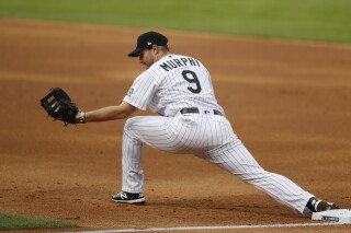 FILE - Colorado Rockies first baseman Daniel Murphy catches a throw during the first inning of the team's baseball game against the San Diego Padres on July 31, 2020, in Denver. Murphy's surprising comeback bid ended with the three-time All-Star infielder going on the voluntarily retired list after playing 38 games with the Los Angeles Angels' Triple-A team. (AP Photo/David Zalubowski, File)