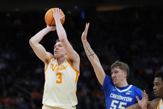 Tennessee guard Dalton Knecht (3) attempts a basket as Creighton guard Baylor Scheierman (55) defends during the first half of a Sweet 16 college basketball game in the NCAA Tournament, Friday, March 29, 2024, in Detroit. (AP Photo/Paul Sancya)