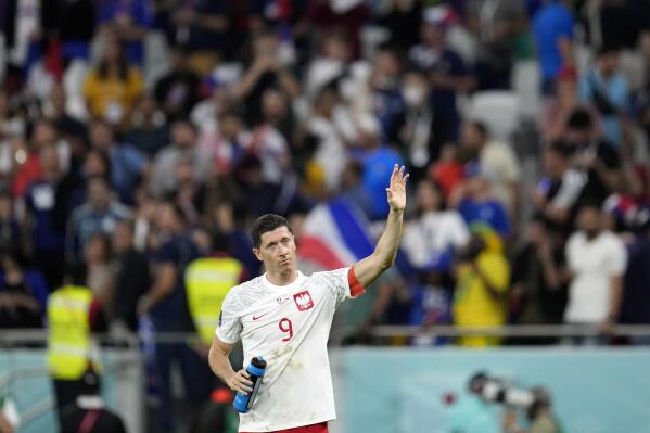 Poland's Robert Lewandowski waves after the World Cup round of 16 soccer match between France and Poland, at the Al Thumama Stadium in Doha, Qatar, Sunday, Dec. 4, 2022. (AP Photo/Natacha Pisarenko)