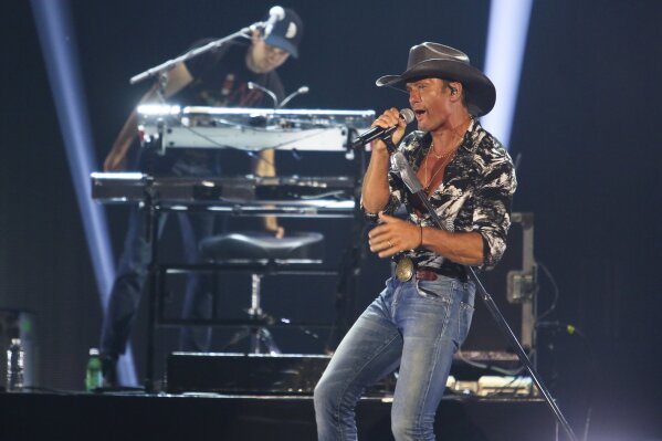 FILE - In this May 4, 2019 file photo, Tim McGraw performs at the iHeartCountry Festival at the Frank Erwin Center in Austin, Texas. The country musician and a political historian may look like an unlikely duo, but McGraw and Pulitzer Prize-winning author Jon Meacham share a common love of history and music. The two wrote “Songs of America: Patriotism, Protest and the Music That Made a Nation,” out Tuesday, June 11 about the impact music has had on American politics, from wars to cultural movements 
 (Photo by Jack Plunkett/Invision/AP, File)