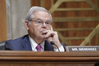 FILE - Sen. Bob Menendez, D-N.J., listens during a Senate Foreign Relations Committee, Thursday, Dec. 7, 2023, in Washington. New obstruction of justice crimes were added Tuesday, March 5, 2024, to charges against Menendez and his wife that allege they accepted gold bars, cash and a luxury car in return for favors the senator carried out to assist three businessmen. Both have pleaded not guilty. (AP Photo/Mariam Zuhaib, File)