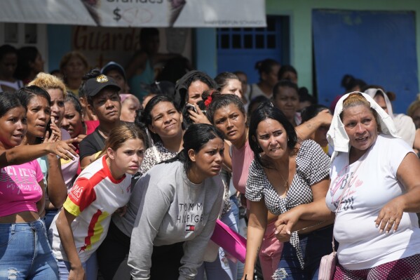 Family members of inmates watch as soldiers raid the Tocorón Penitentiary Center, in Tocorón, Venezuela, Sept. 20, 2023. (AP Photo/Ariana Cubillos, File)