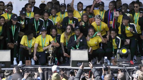 FILE - South Africa's women's soccer team pose for photographers and fans during a welcome ceremony at the OR Tambo International Airport in Johannesburg, South Africa, July 26, 2022, after winning the Women's Africa Cup of Nations in Morocco last July 23. A standoff between South Africa's Women's World Cup squad and the national soccer association over pay and other issues forced officials to field a stand-in team of little-known players that included a 13-year-old girl for a game against Botswana on Sunday July 2, 2023. (AP Photo/Themba Hadebe, File)