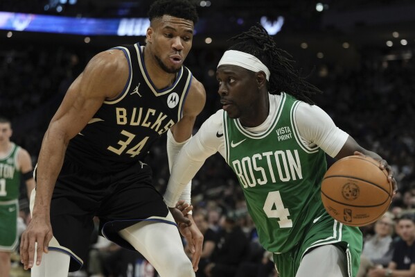 Boston Celtics' Jrue Holiday gets past Milwaukee Bucks' Giannis Antetokounmpo during the first half of an NBA basketball game Tuesday, April 9, 2024, in Milwaukee. (AP Photo/Morry Gash)