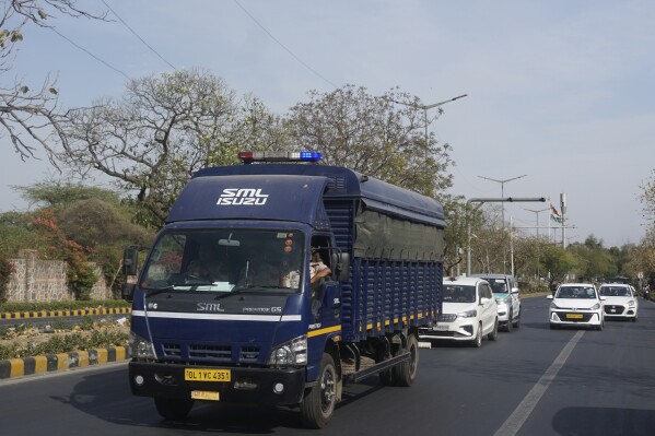 Security vehicles escort a police van carrying Arvind Kejriwal, leader of the Aam Admi Party, or Common Man's Party, to Tihar prison from a local court, in New Delhi, India, Monday, April 1, 2024. A court in India on Monday placed a top opposition leader in two weeks of judicial detention after his 10 days in the custody of a federal agency expired, in a case that opposition parties say is part of a crackdown by Prime Minister Narendra Modi’s government on rivals ahead of a national election later this month. (AP Photo/Dinesh Joshi)