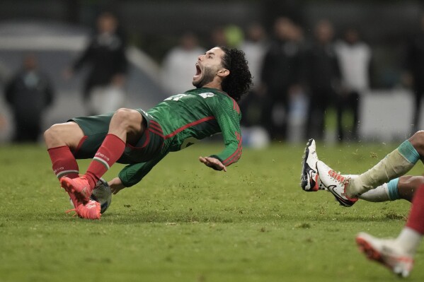 Mexico's Cesar Huerta falls on the pitch after he is fouled by Honduras' Denil Maldonado, during a CONCACAF Nations League quarterfinal second leg soccer match, at Azteca stadium in Mexico City, Tuesday, Nov. 21, 2023. El Tri went on to defeat Honduras 4-2 on penalty kicks to qualify for next year's Copa America. (AP Photo/Eduardo Verdugo)