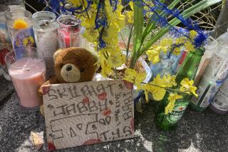 FILE - In this April 28, 2021, file photo, a stuffed bear sits with other tributes at a street memorial where Honolulu Police shot and killed 16-year-old Iremamber Sykap, whose nickname was Baby, during a car chase on Kalakaua Ave., in Honolulu.  Grand jurors have declined to indict three Honolulu police officers in a shooting that killed a 16-year-old boy. The Honolulu prosecuting attorney's office said it presented evidence to a grand jury Wednesday, June 9, 2021 seeking indictments of the three officers. The grand jury declined to return indictments for any of the officers in the April 5 shooting that killed Iremamber Sykap, it said.  (AP Photo/Jennifer Sinco Kelleher, File)