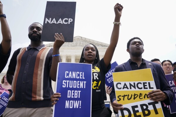 Jordan Braithwaite, 21, center, an undergrad at Grambling State University facing over $10,000 in student loans, demonstrates outside the Supreme Court, Friday, June 30, 2023, in Washington. A sharply divided Supreme Court has ruled that the Biden administration overstepped its authority in trying to cancel or reduce student loan debts for millions of Americans. Conservative justices were in the majority in Friday's 6-3 decision that effectively killed the $400 billion plan that President Joe Biden announced last year. (APPhoto/Jacquelyn Martin)