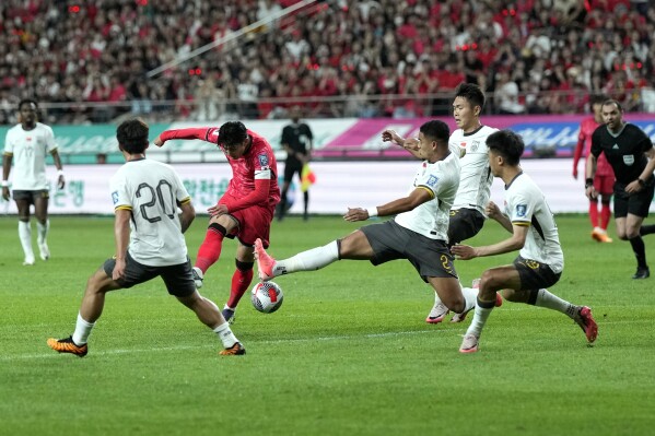 South Korea's Son Heung-min, center left, makes an attempt to score during the second round of the Asian qualifier group C match for 2026 FIFA World Cup between South Korea and China at Seoul World Cup Stadium in Seoul, South Korea, Tuesday, June 11, 2024. (AP Photo/Lee Jin-man)