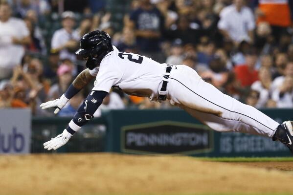 Detroit Tigers' Javier Baez dives into third base with a triple against the Chicago White Sox during the fifth inning of a baseball game Friday, Sept. 16, 2022, in Detroit. (AP Photo/Duane Burleson)