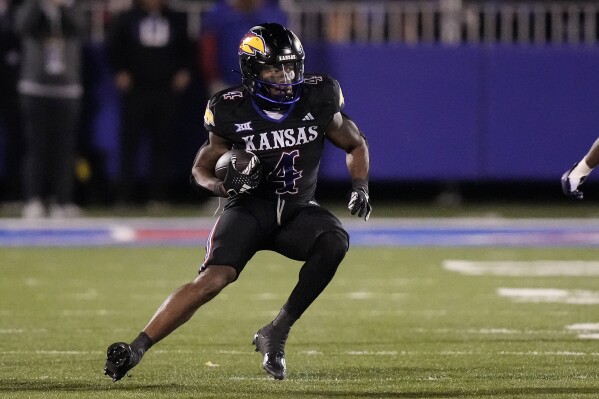 Kansas running back Devin Neal runs the ball during the second half of an NCAA college football game against Kansas State Saturday, Nov. 18, 2023, in Lawrence, Kan. (AP Photo/Charlie Riedel)