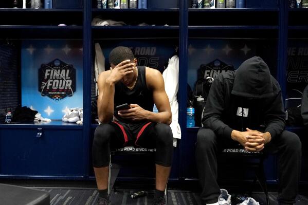 San Diego State guard Micah Parrish and guard Tyler Broughton sit in the locker room after their loss against Connecticut in the men's national championship college basketball game in the NCAA Tournament on Monday, April 3, 2023, in Houston. (AP Photo/Brynn Anderson)