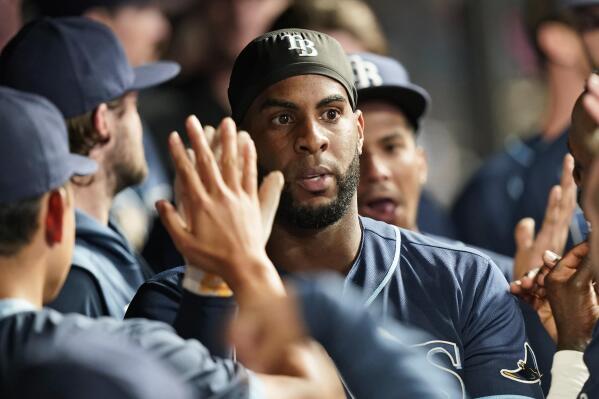 Tampa Bay Rays' Yandy Diaz celebrates with teammates after hitting a solo home run in the ninth inning of a baseball game against the Cleveland Indians, Thursday, July 22, 2021, in Cleveland. (AP Photo/Tony Dejak)