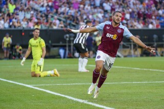 Aston Villa's Emiliano Buendía, right, reacts after his goal against Newcastle United's Martin Dubravka, left, during the first half of an English Premier League Summer Series soccer match, Sunday, July 23, 2023 in Philadelphia. (AP Photo/Chris Szagola)