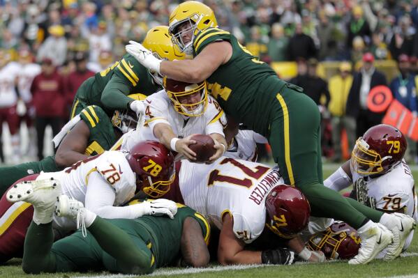 Washington Football Team's Taylor Heinicke is stopped at the goal line on fourth down during the second half of an NFL football game against the Green Bay Packers Sunday, Oct. 24, 2021, in Green Bay, Wis. (AP Photo/Aaron Gash)