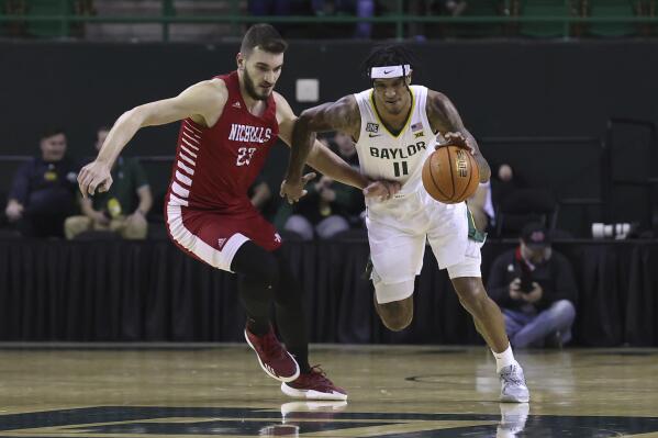 Baylor forward Jalen Bridges (11) steals the ball from Nicholls State forward Edoardo Del Cadia (23) during the first half of an NCAA college basketball game Wednesday, Dec. 28, 2022, in Waco, Texas. (AP Photo/Jerry Larson)