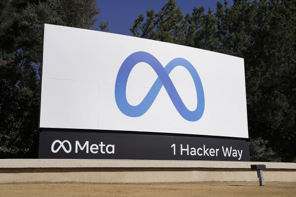 FILE - Facebook's Meta logo sign is seen at the company headquarters in Menlo Park, Calif. on Oct. 28, 2021. Meta CEO Mark Zuckerberg said Tuesday, July 18, 2023, the company is partnering with Microsoft to introduce the next generation of its AI large language model and making the technology known as LLaMA 2 free for research and commercial use. (AP Photo/Tony Avelar, File)