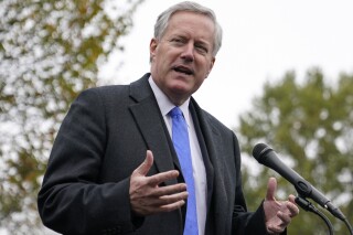 FILE - White House chief of staff Mark Meadows speaks with reporters outside the White House, Monday, Oct. 26, 2020, in Washington. A federal appeals court will hear arguments Friday, Dec. 15, 2023, over whether the election interference charges filed against Trump White House chief of staff Mark Meadows should be moved from a state court to federal court. (AP Photo/Patrick Semansky, File)