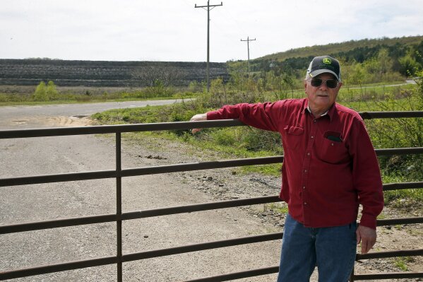 
              In this April 8, 2019, photo, Tim Tanksley, who has been fighting for years trying to convince Oklahoma lawmakers to crack down on the coal ash dumping, stands outside a dump site in Bokoshe, Okla. President Donald Trump’s EPA has approved Oklahoma to be the first state to take over permitting and enforcement on coal-ash sites. “They’re going to do absolutely nothing,” Tanksley said. (AP Photo/Sue Ogrocki)
            