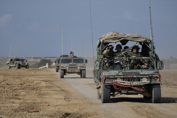 Israeli forces move near the Gaza Strip border in southern Israel, Thursday, Jan. 25, 2024. The army is battling Palestinian militants across Gaza in the war ignited by Hamas' Oct. 7 attack into Israel. (AP Photo/Ohad Zwigenberg)