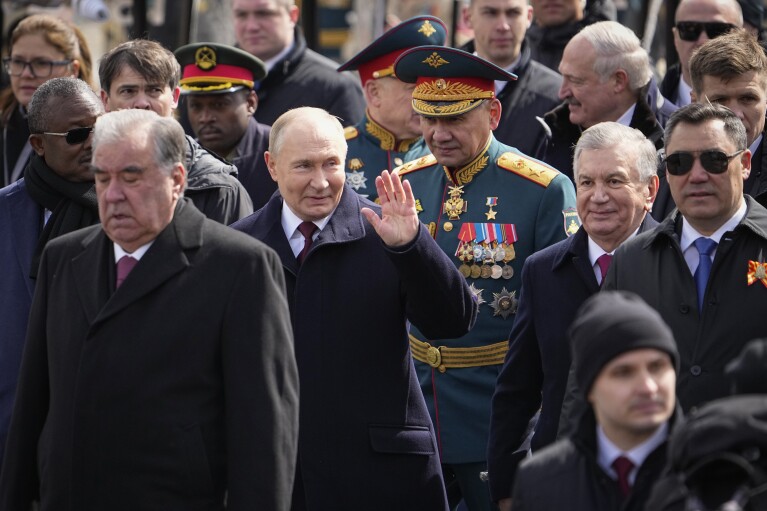 President of the Republic of Tajikistan, Emomali Rahmon, front left, Russian President Vladimir Putin, center, Russian Defense Minister Sergei Shoigu, center right, President of the Republic of Uzbekistan, Shavkat Mirziyoyev, second from the right, and the President of the Kyrgyz Republic, Sadyr Japarov.  Right, exit Red Square after the Victory Day military parade in Moscow, Russia, Thursday, May 9, 2024, marking the 79th anniversary of the end of World War II.  (AP Photo/Alexander Zemlianichenko)
