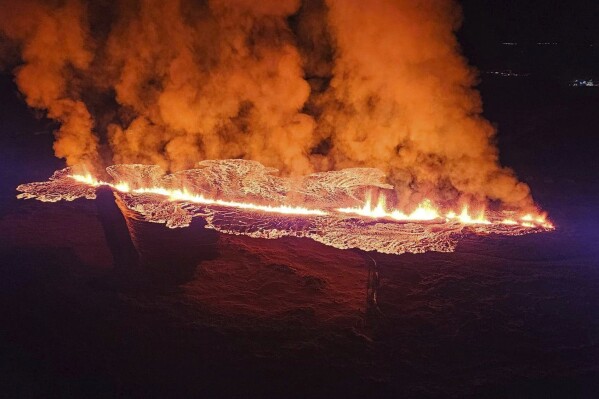 In this photo provided by Civil Protection taken from the Coast Guard's helicopter, a view of lava as the volcano erupts near Grindavík, Iceland, Sunday, Jan. 14. 2024.A volcano has erupted in southwestern Iceland, sending semi-molten rock spewing toward a nearby settlement for the second time in less than a month. Iceland's Icelandic Meteorological Office says the eruption Sunday came after a swarm of earthquakes near the town of Grindavik. (Icelandic Civil Protection via AP)