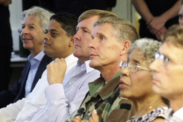 
              Dutch King  Willem-Alexander watches a presentation regarding hurricane response after the passing of Hurricane Irma in Willemstad, Curacao, Monday, Sept. 11, 2017. If the weather is good enough, the monarch will later fly onward to St. Maarten and two other smaller islands hit by Irma on Wednesday to offer his support to the thousands of residents and Dutch marines helping to clear the island, where some 70 percent of homes were badly damaged or destroyed by the Category 5 storm. (Henky Looman/Curacao government via AP)
            