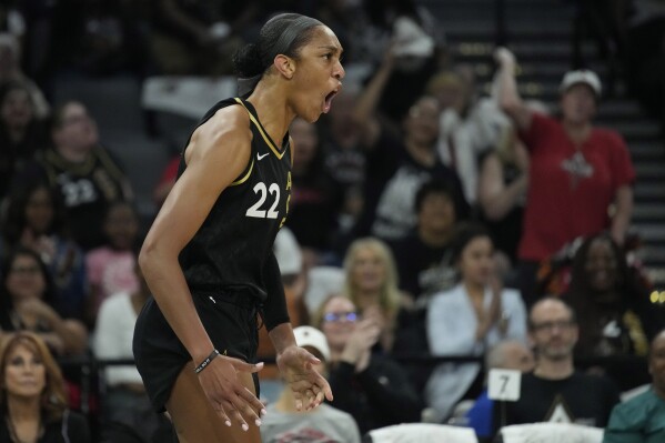 Las Vegas Aces forward A'ja Wilson (22) celebrates after a play against the Dallas Wings during the first half in Game 2 of a WNBA basketball semifinal series Tuesday, Sept. 26, 2023, in Las Vegas. (AP Photo/John Locher)