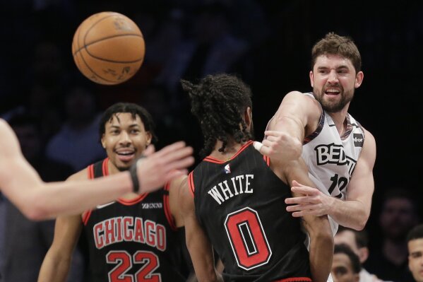 Brooklyn Nets' Joe Harris, right, passes around Chicago Bulls defenders during the first half of an NBA basketball game at the Barclays Center, Sunday, March 8, 2020, in New York. (AP Photo/Seth Wenig)
