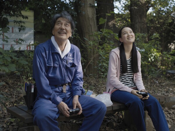 This image released by Neon shows K么ji Yakusho, left, and Arisa Nakano in a scene from "Perfect Days." (Neon via AP)
