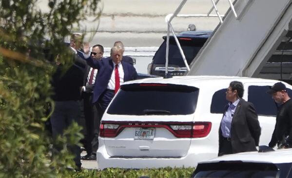 Former president Donald Trump waves before boarding his plane at Palm Beach International Airport, Monday, April 3, 2023, in West Palm Beach, Fla. Trump is heading to New York for his expected booking and arraignment on charges arising from hush money payments during his 2016 campaign. (Joe Cavaretta/South Florida Sun-Sentinel via AP)
