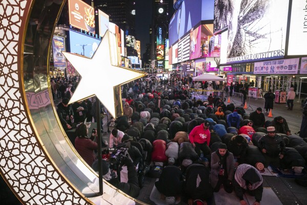 Members of the Muslim community gather for the Taraweeh prayer during a month of Ramadan at New York's Times Square, Sunday, March 10, 2024. (AP Photo/Yuki Iwamura)