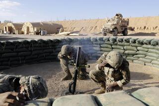 FILE - In this Jan. 24, 2018, file photo, U.S. Army soldiers conduct a mortar exercise at a small coalition outpost in western Iraq near the border with Syria. As with most legislative victories, many organizations played a role in the 268-161 House vote to repeal the 2002 Authorization for Use of Military Force, which originally authorized then-President George W. Bush’s invasion of Iraq. But few focused on the issue longer or more doggedly than the Friends Committee on National Legislation, which has toiled for years to stop what it describes as the “endless wars” launched by the United States. (AP Photo/Susannah George, File)