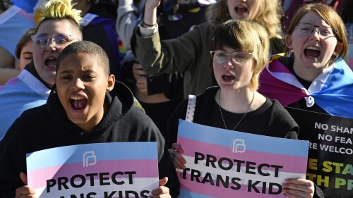 FILE - Protesters of Kentucky Senate Bill SB150, known as the Transgender Health Bill, cheer on speakers during a rally on the lawn of the Kentucky Capitol in Frankfort, Ky., March 29, 2023. A federal judge temporarily blocked Kentucky’s ban on gender-affirming care for transgender youths on Wednesday, June 28, taking the action shortly before the measure was set to take effect. (AP Photo/Timothy D. Easley, File)