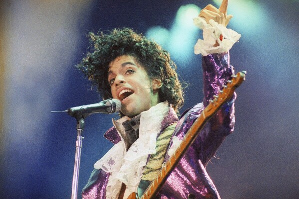 FILE - Prince performs at the Forum in Inglewood, Calif., on Feb. 18, 1985. Apple Music announced on Wednesday, May 22, 2024, their 10 greatest albums of all time and Prince and the Revolution's 1984 “Purple Rain” came in fourth on the list. (AP Photo/Liu Heung Shing, File)