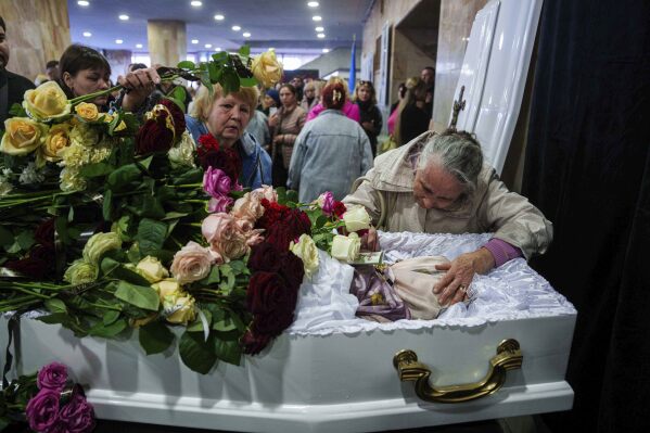 Mother Natalia says goodbye to her daughter Olena Kohut, an orchestra musician who was killed in a deadly Palm Sunday Russian attack on Sumy on April 13, during a farewell ceremony in Sumy, Ukraine, April 15, 2025. (AP Photo/Evgeniy Maloletka)