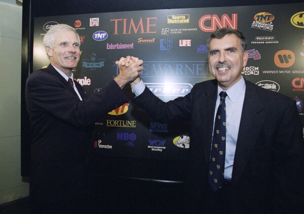 FILE - Turner Broadcasting Chairman and President Ted Turner, left, and Time Warner Chairman and CEO Gerald Levin pose for photographers prior to a news conference at the Time Life Building, Friday, Sept. 22, 1995, in New York. Levin, who led Time Warner Media into a disastrous $112 billion merger with the internet provider America Online, died Wednesday, March 13, 2024. He was 84. (AP Photo/Richard Drew, File)