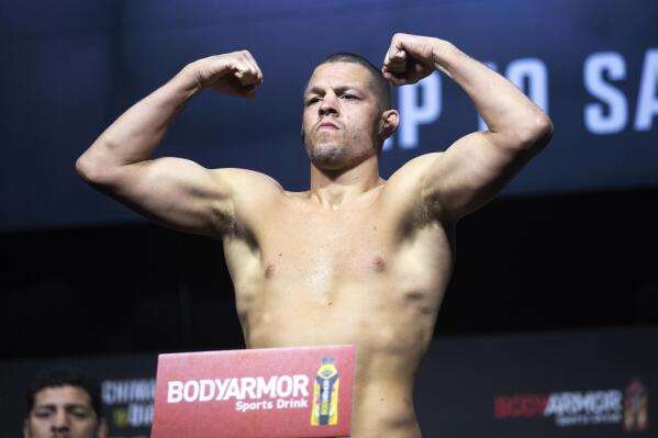 FILE - Welterweight fighter Nate Diaz poses on the scale during a ceremonial weigh-in for the UFC 279 mixed martial arts event on Sept. 9, 2022, in Las Vegas. YouTube sensation Jake Paul will take on former UFC veteran Diaz in a boxing match on Aug. 5, 2023, in Dallas. (Steve Marcus/Las Vegas Sun via AP, File)