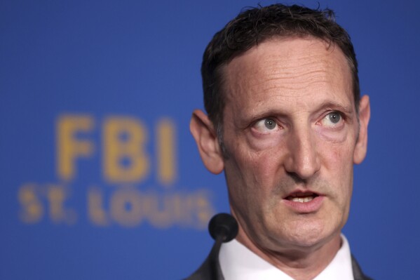 FBI Special Agent In Charge Jay Greenberg, right, speaks during a news conference Wednesday, Oct. 18, 2023, at the Federal Bureau of Investigation's St. Louis field office in downtown St. Louis. Thousands of information technology workers contracting with U.S. companies have for years secretly sent millions of dollars of their wages to North Korea for use in its ballistic missile program, FBI and Department of Justice officials said. (Christine Tannous/St. Louis Post-Dispatch via AP)