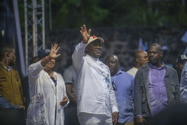 FILE - Democratic Republic of the Congo President Felix Tshisekedi, center, flanked by his wife Denise Nyakeru, greets supporters at a rally in Goma, Eastern Congo, on Dec. 10, 2023. Tshisekedi is seeking reelection in Dec. 20 elections. (AP Photo/Moses Sawasawa, File)