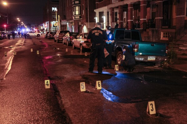 FILE - Police on the scene of a shooting Monday, July 3, 2023 in Philadelphia. A man who previously had been found mentally incompetent to stand trial on charges he killed five people and wounded several others in Philadelphia in early July appeared for a preliminary hearing Tuesday, March 19, 2024, and his lawyers said he has been receiving treatment and medication. (Steven M. Falk/The Philadelphia Inquirer via AP, File)