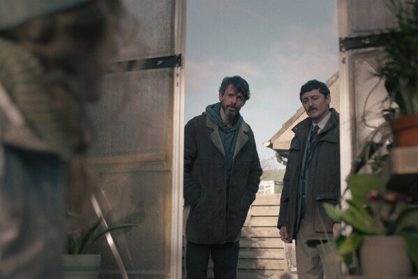 This image released by Netflix shows Matthew Goode, left, and Alexej Manvelov in a scene from the series "Dept. Q." (Netflix via AP)