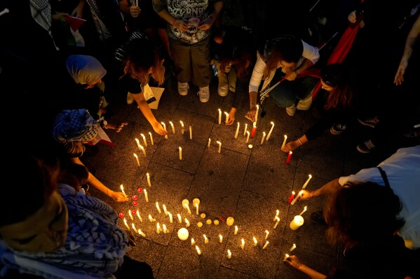 FILE - Hundreds of people with their children light candles during a march against Israel's attack on the Gaza Strip, on the Mediterranean Sea corniche in Beirut, Lebanon, Friday, Nov. 10, 2023. (AP Photo/Bilal Hussein, File)